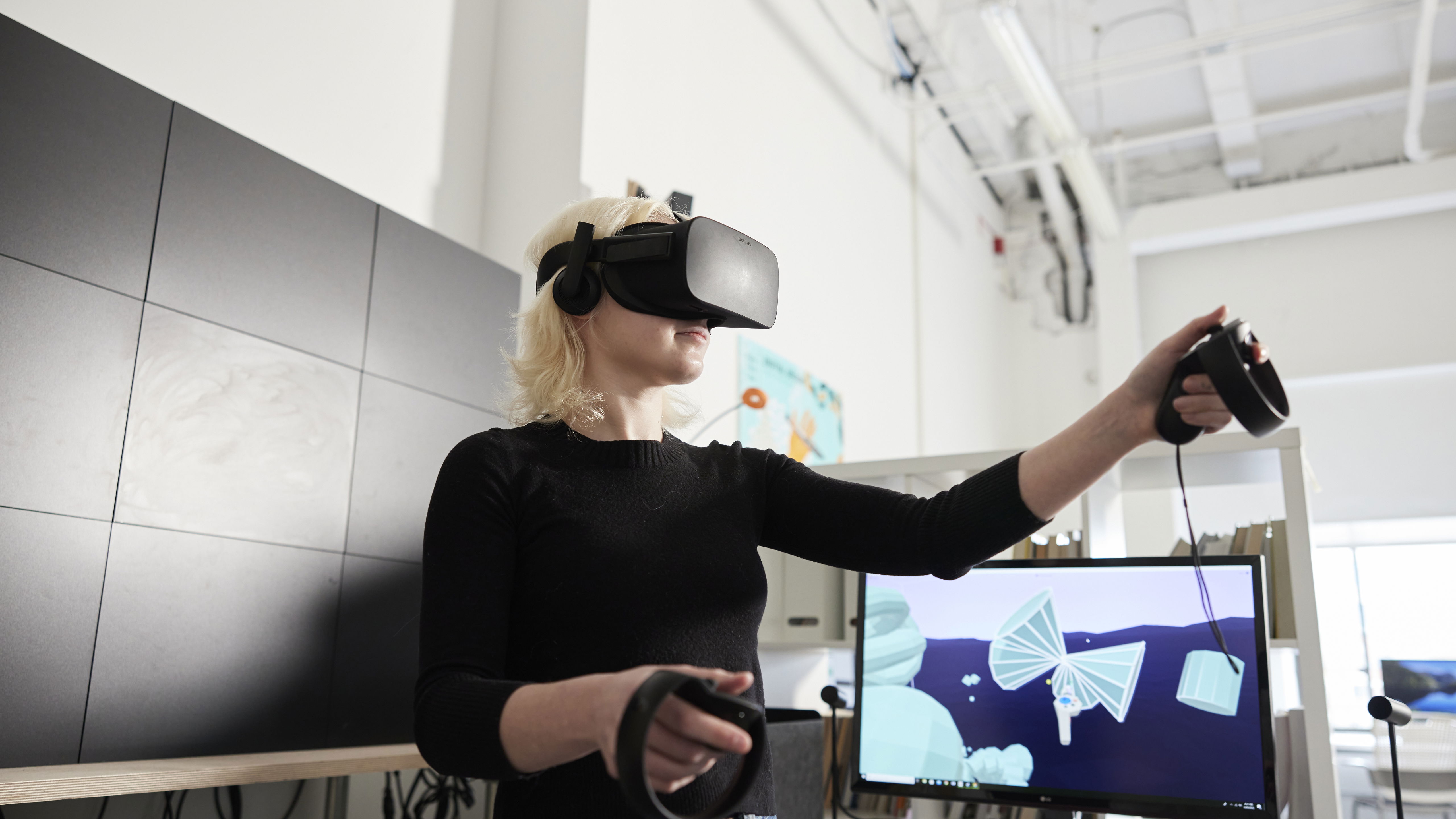 A Willamette student using virtual reality equipment in a classroom