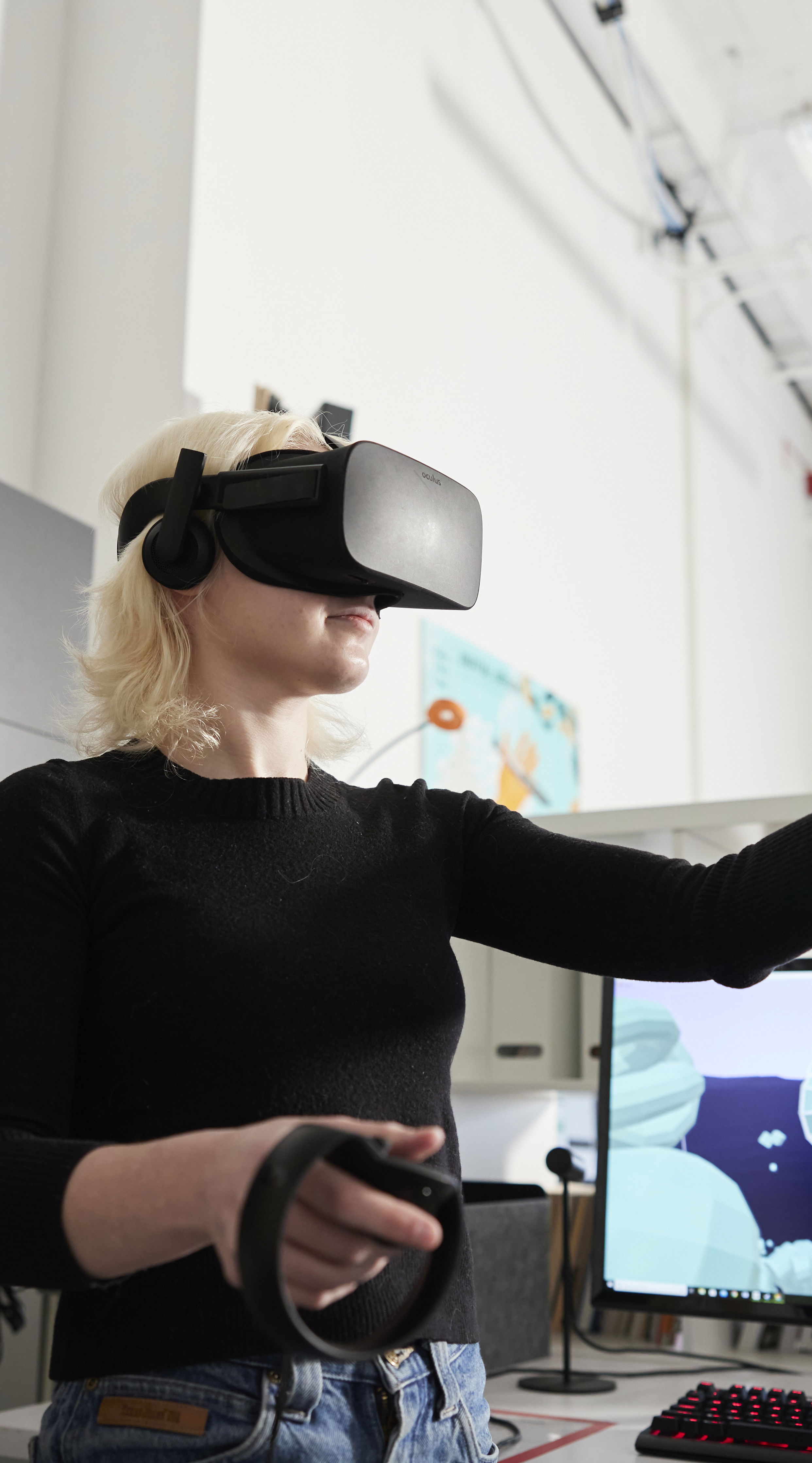 A Willamette student using virtual reality equipment in a classroom