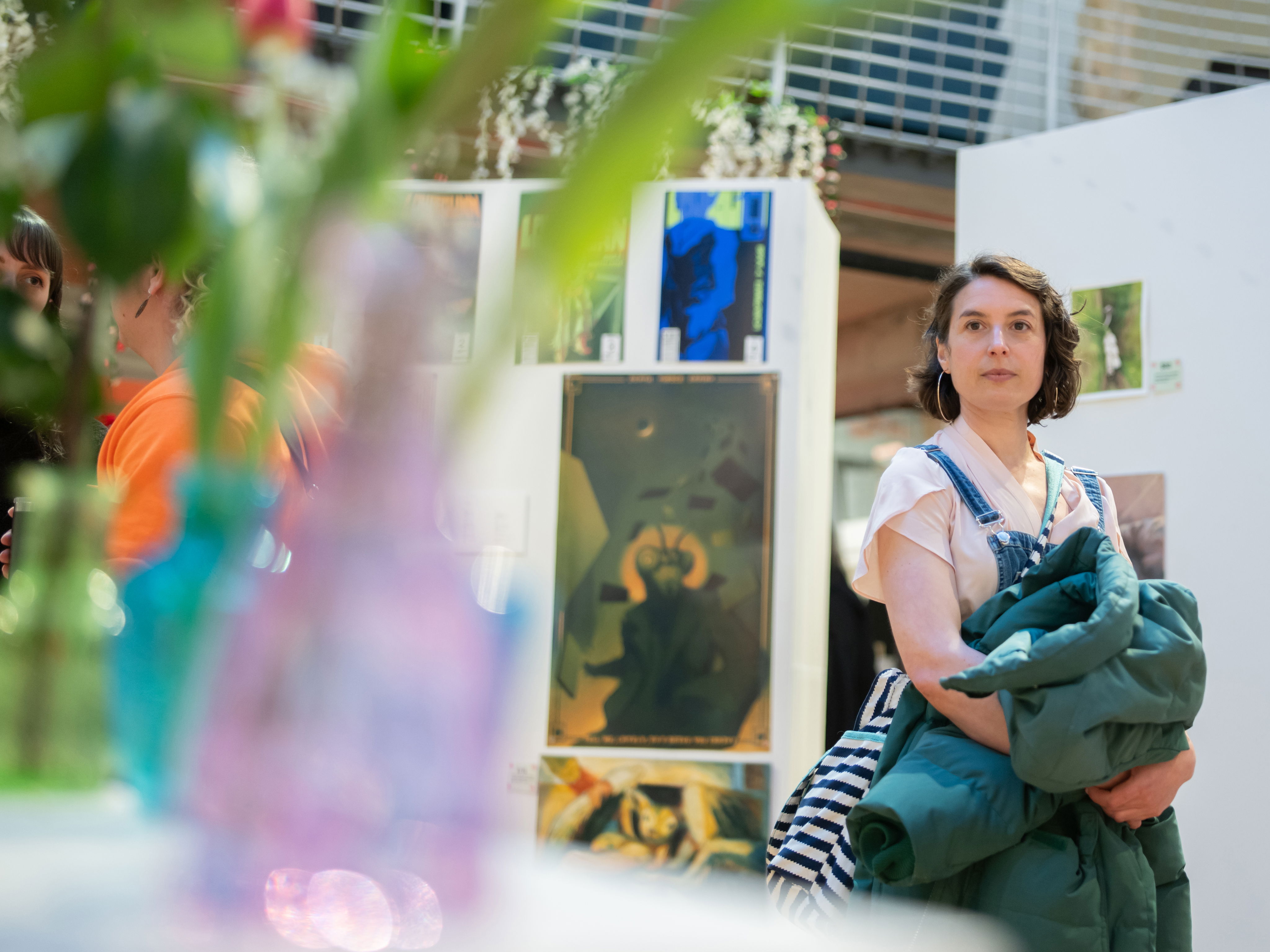 A person walks through gallery displays at PNCA's First Thursday event.