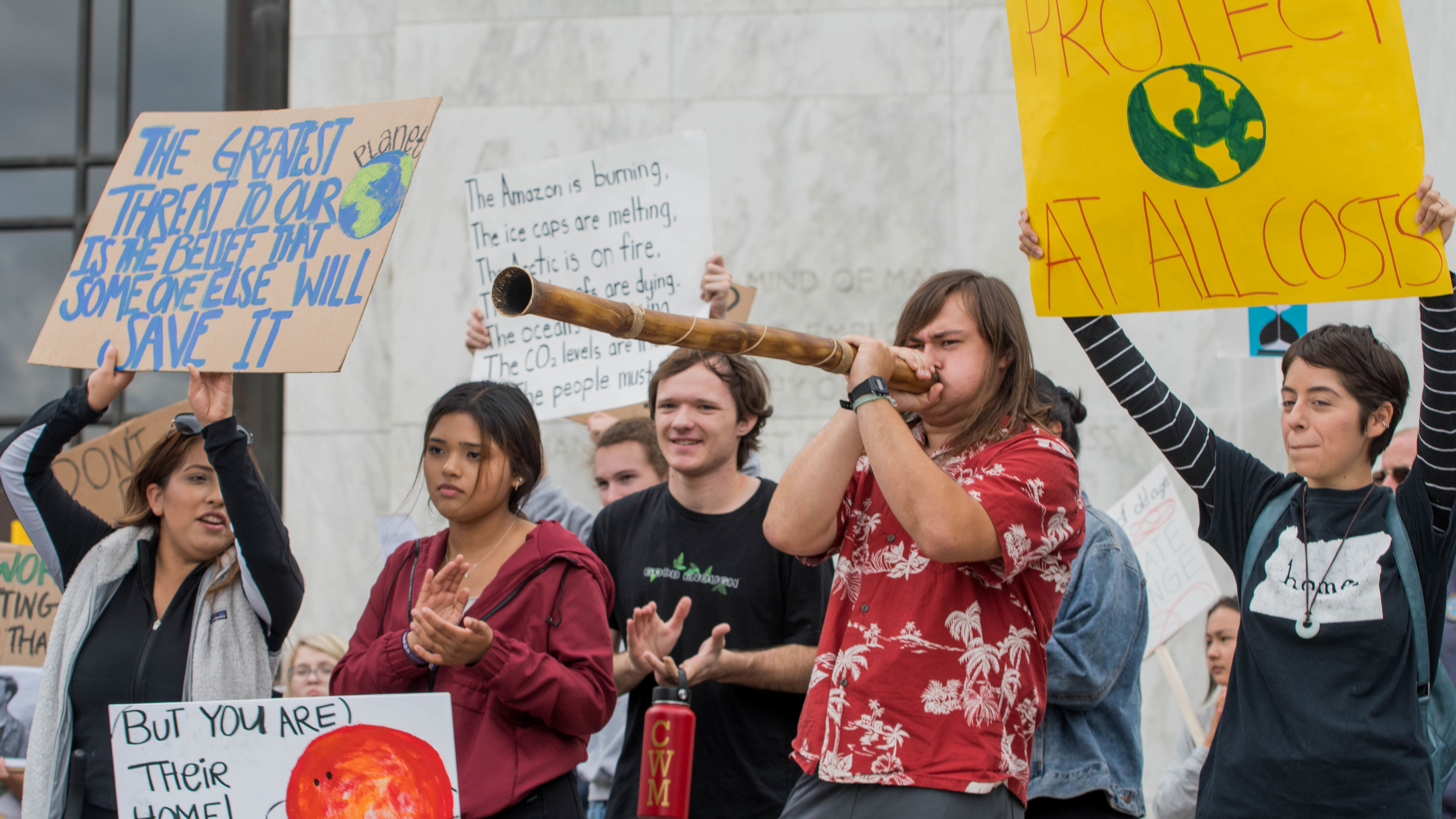 Climate activism, students holding signs and protesting for the earth