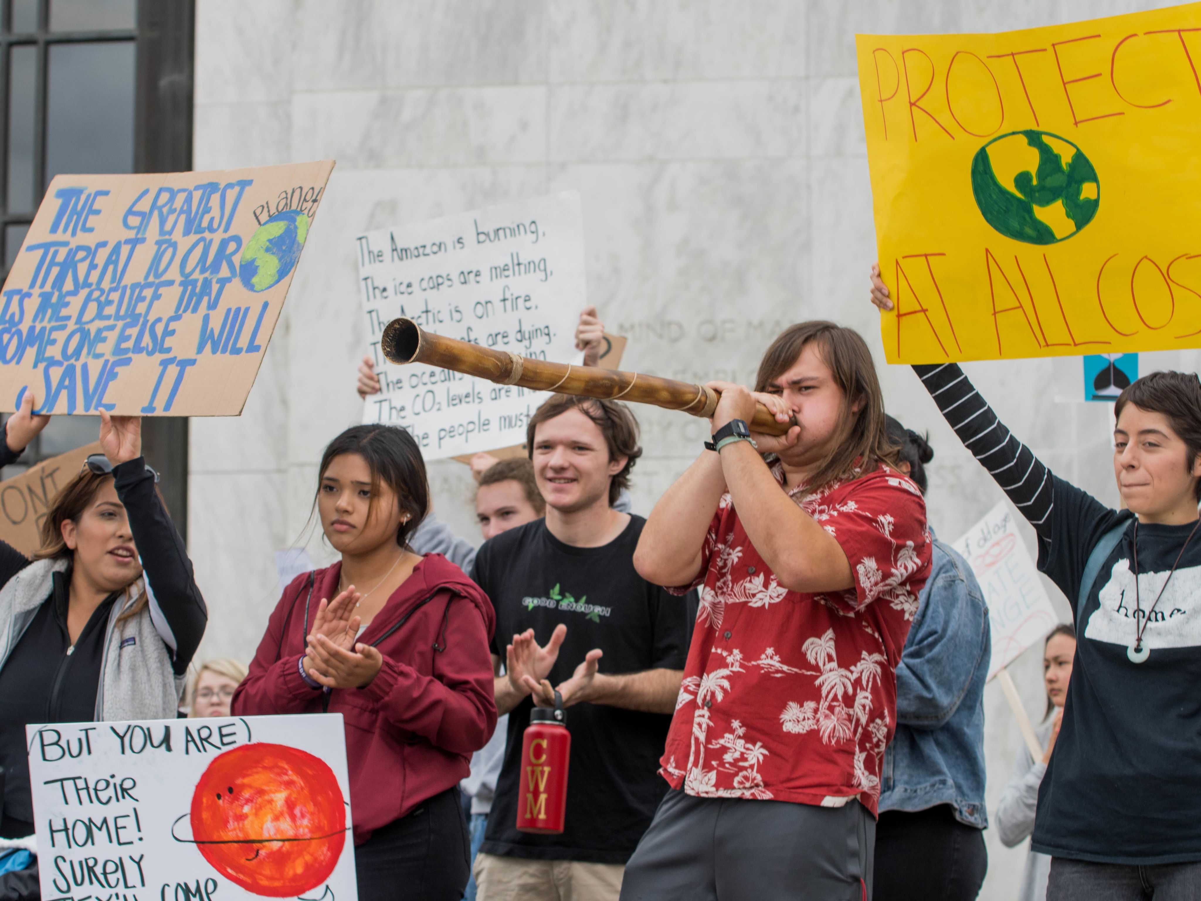 Climate activism, students holding signs and protesting for the earth