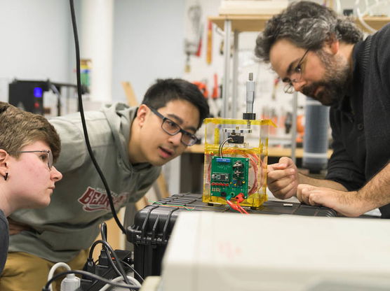 Physics professor and students in a classroom.