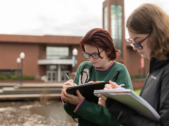 Students taking notes by the Millstream