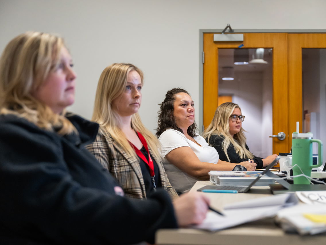 Four students listening to a lecture