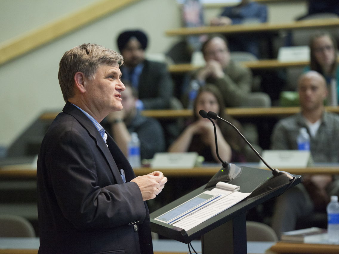 Person speaking at a lectern in front of law students