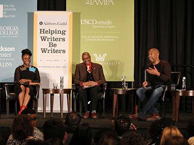 Three people on a stage at a conference for Helping Writers Be Writers.