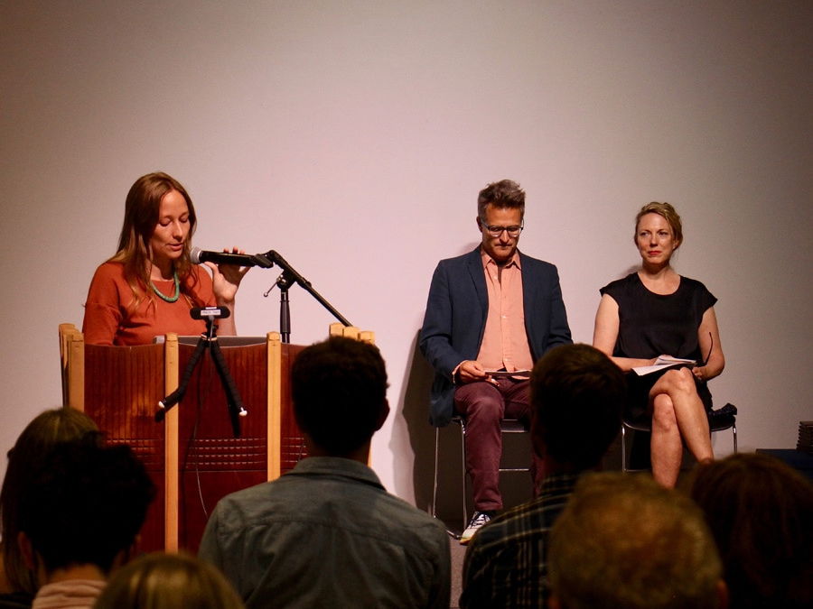 Three people speaking at a confrence