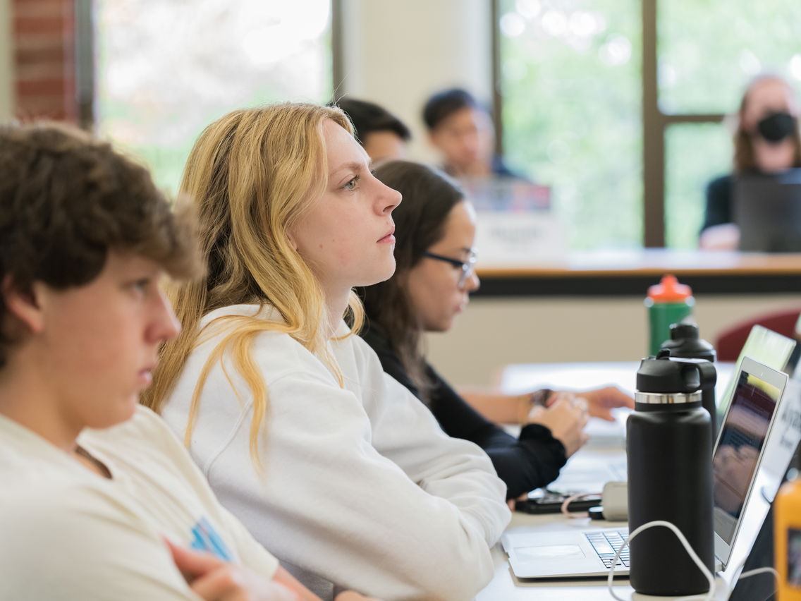 Students in a row looking up in a classroom