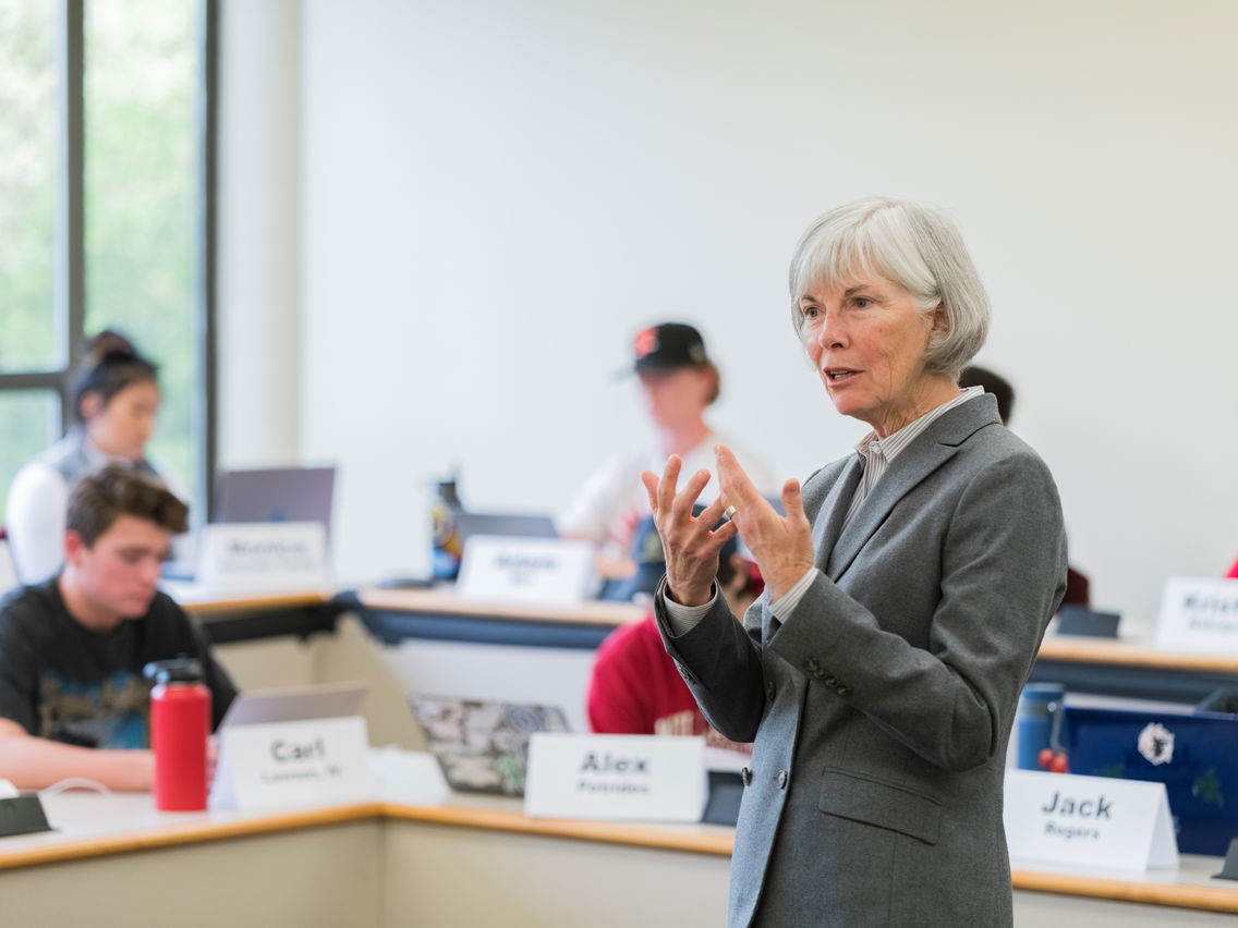 A professor talking in front of a classroom of students