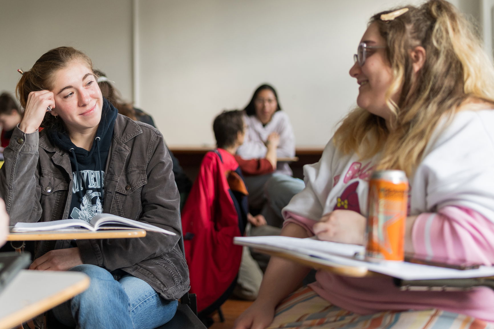 Two students in a lecture classroom.