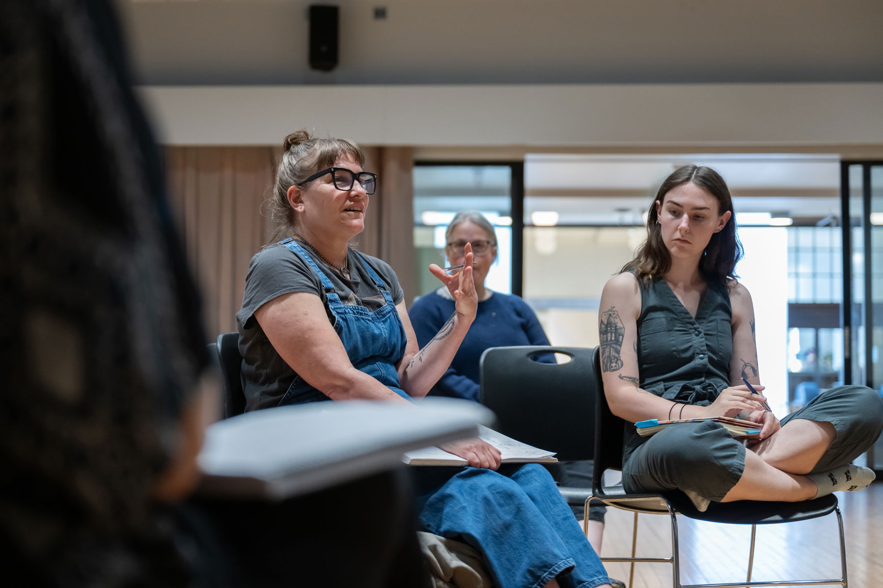 Three students where one person is conveying a concept.