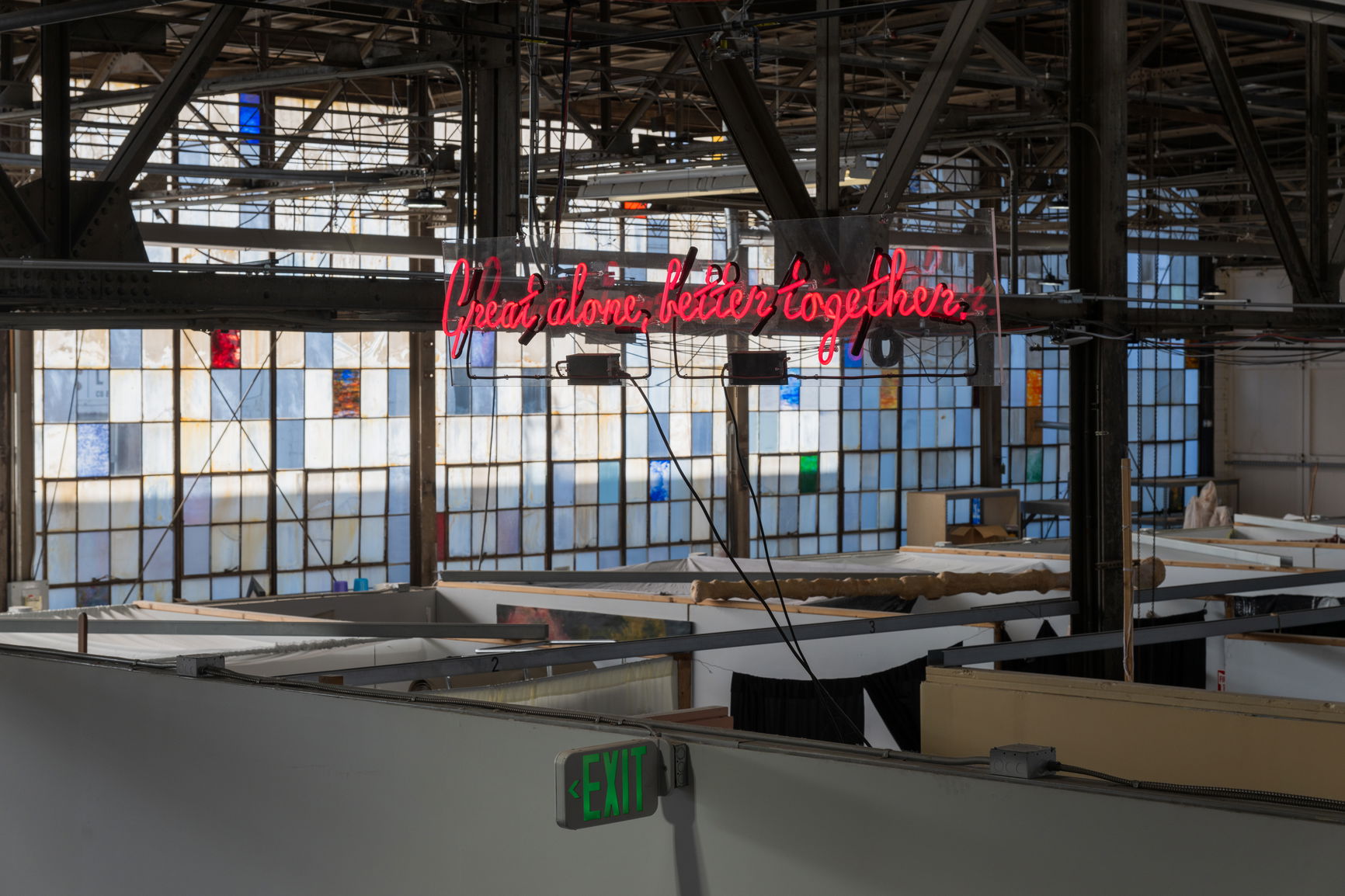 a red neon sign in an industrial studio space