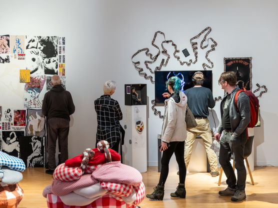 a group of people view an art exhibition with modern art