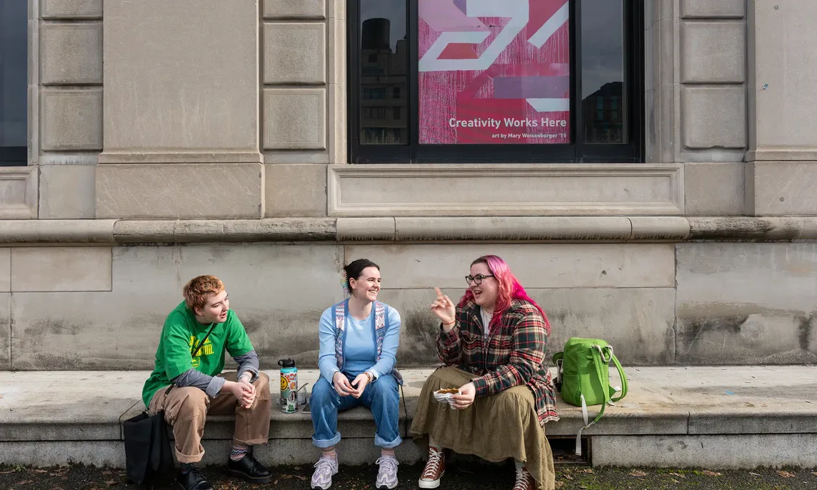 Three students chatting outside of the PNCA building