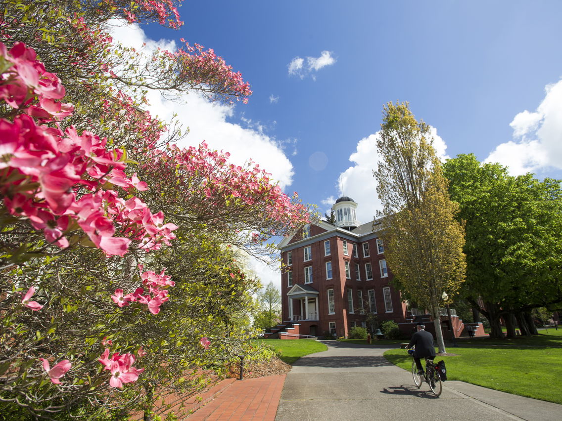 Person on a bike heading toward Waller Hall at Willamette University in Salem, Oregon.