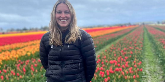 Elana Greenberg in a field of flowers.