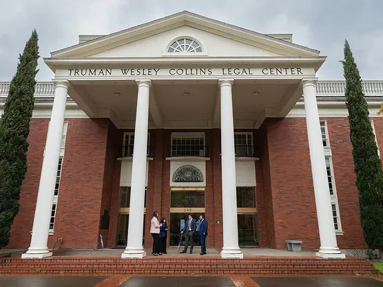 Four Law students stand in front of Willamette University's School of Law in Salem, Oregon