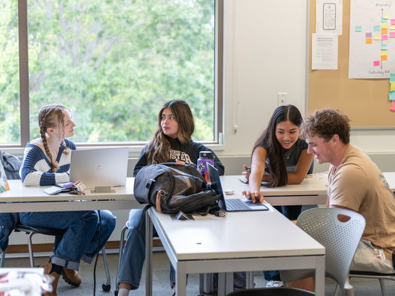 a group of students collaborate on a project in a classroom