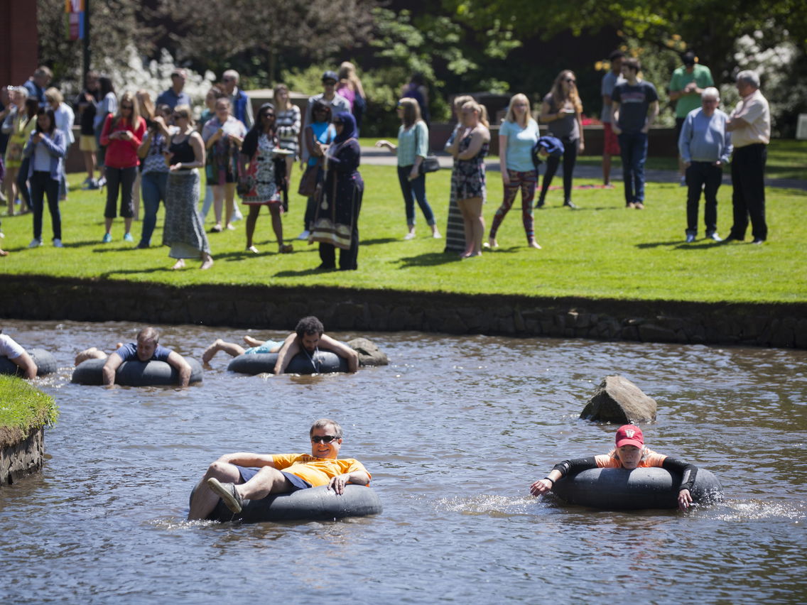 Students, faculty, and even Willamette's President at the annual Brownwater Regatta - participants float down the Mill Stream