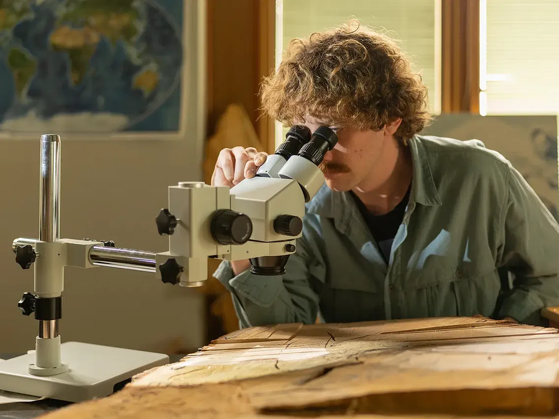 Brice using a microscope