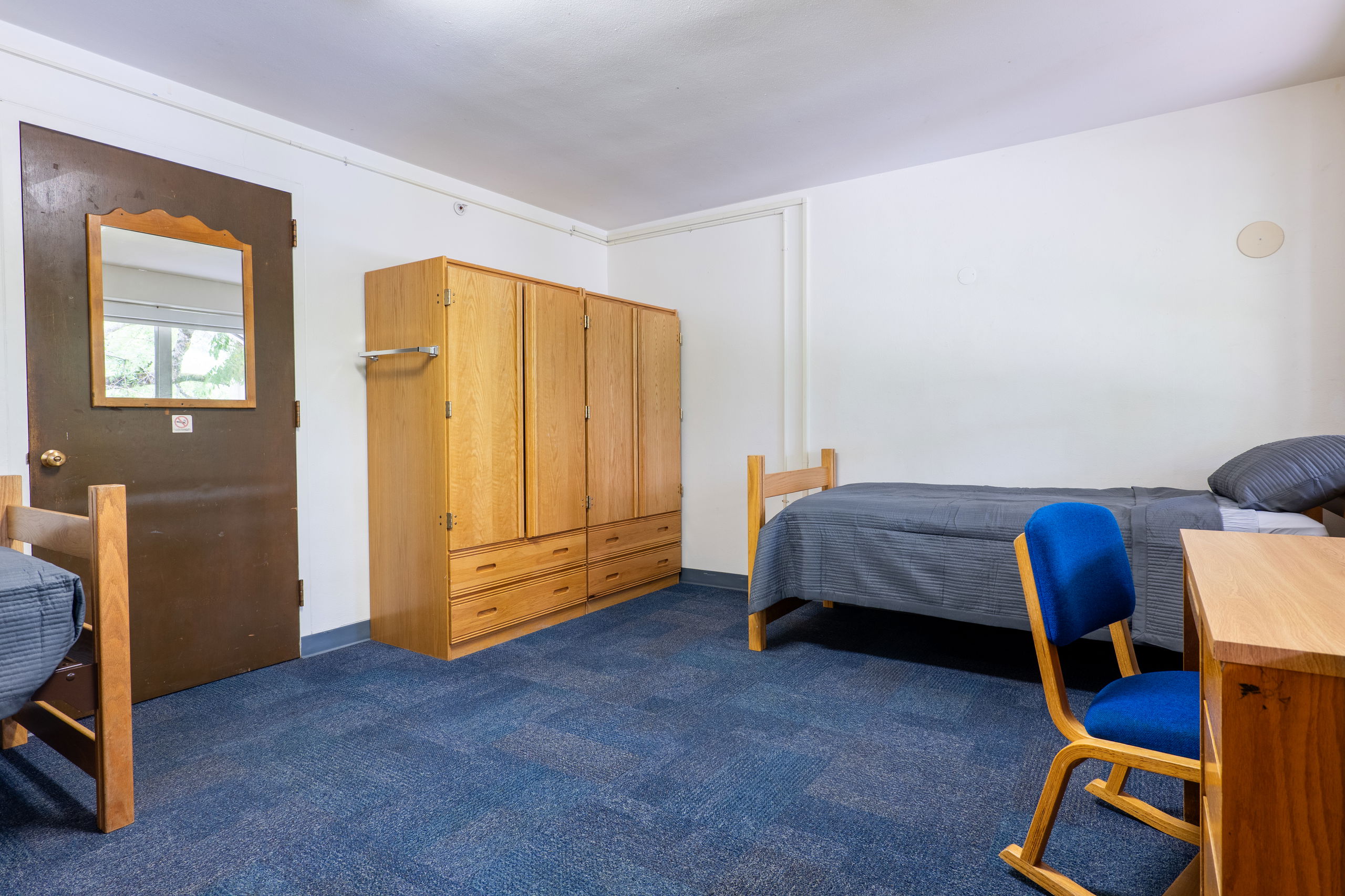 Doney double showing beds, closets, desks, and chairs