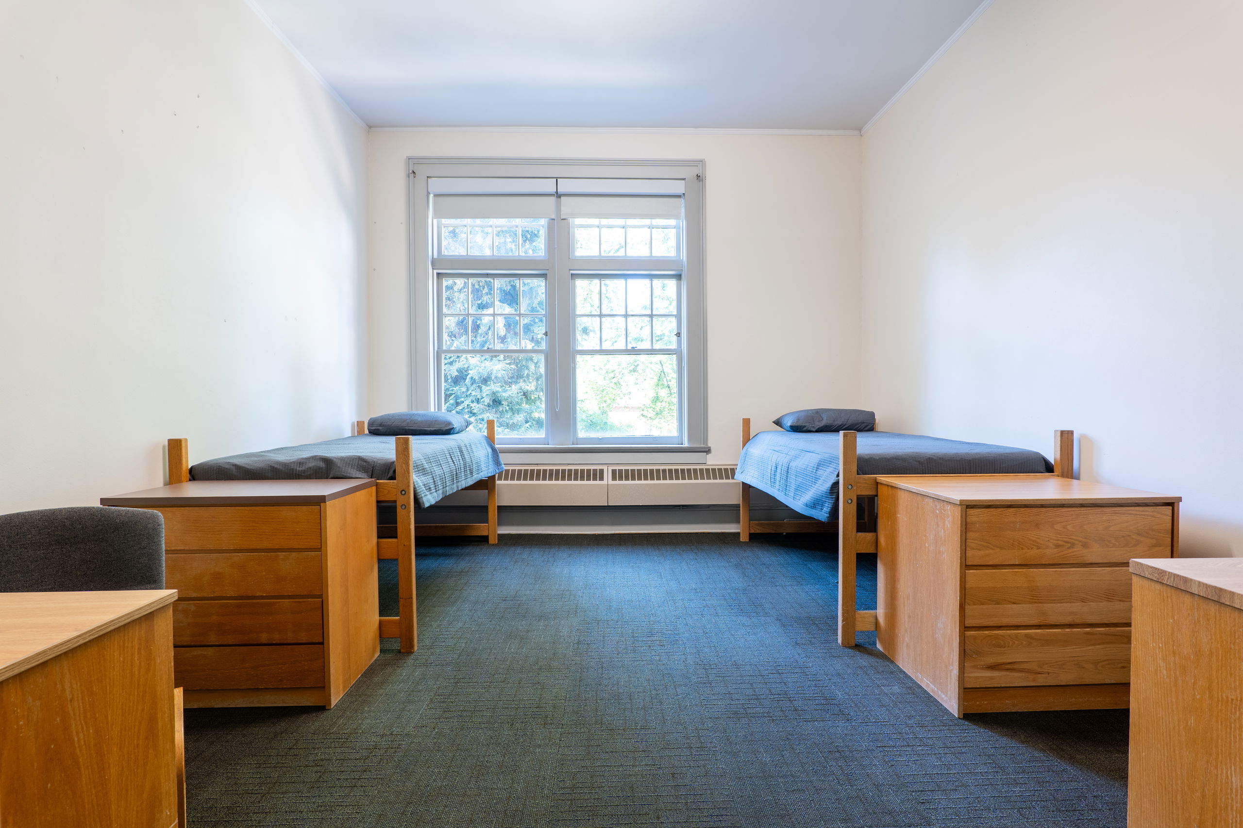 Double room with beds, desks, dressers, and chairs