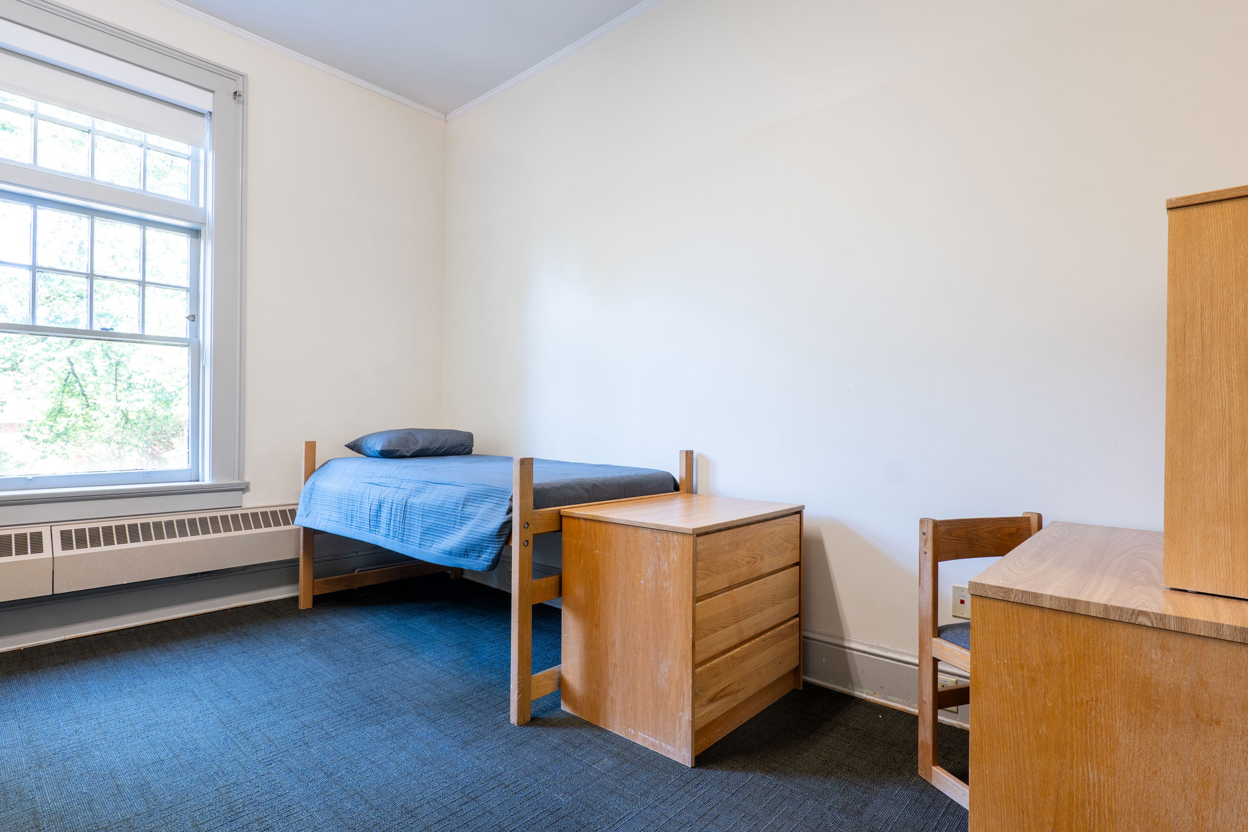 Double room with beds, desks, dressers, and chairs