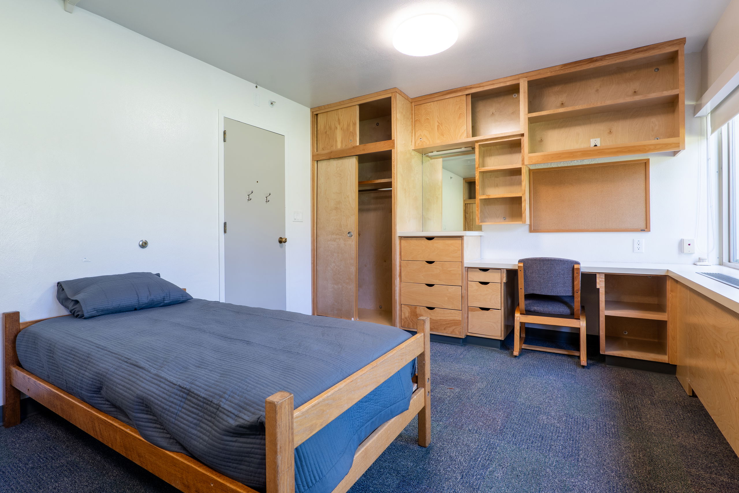 York double room with beds, built in desks and shelves, chairs and closets