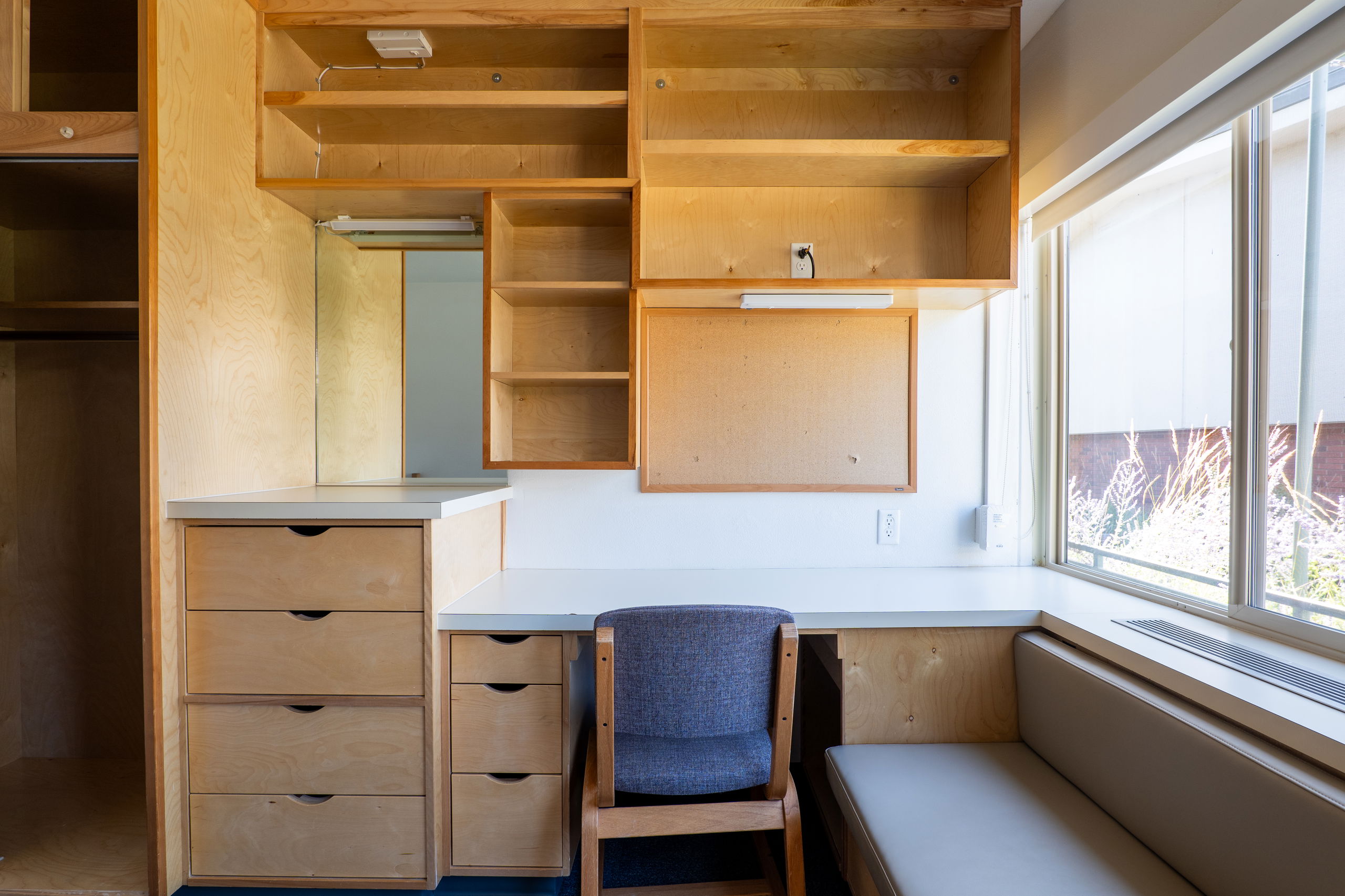 York single room image of built in desk and storage areas with a chair