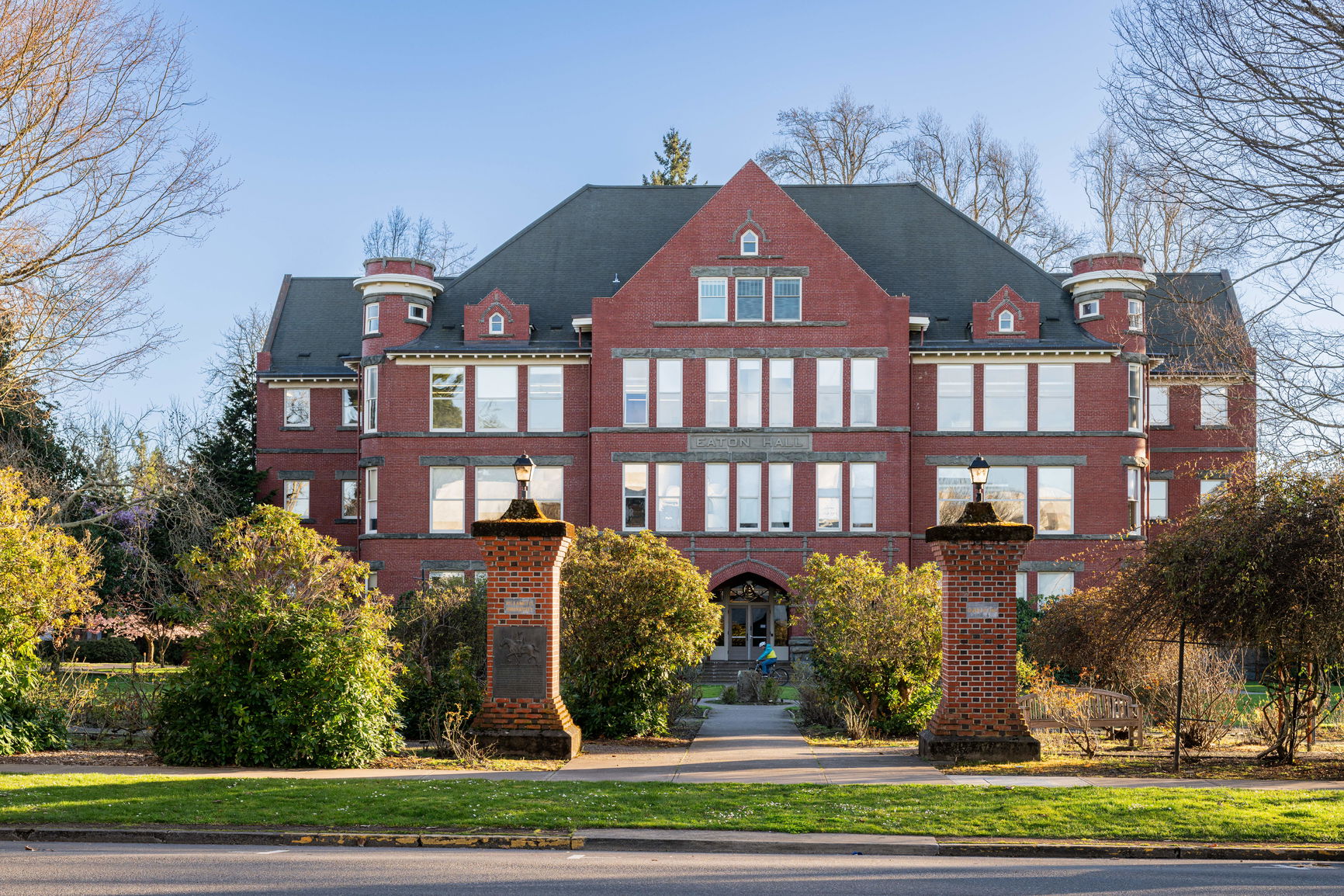 Willamette University's Eaton Hall, a Gothic-style red brick building with a rose garden in front