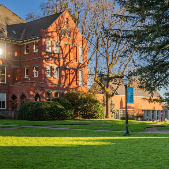 Willamette University's Eaton Hall, a Gothic-style red brick building on a large green lawn