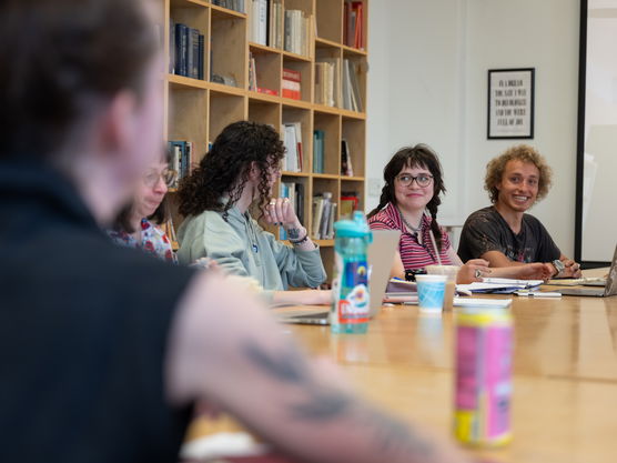 Several PNCA students sit around a table during a creative writing workshop