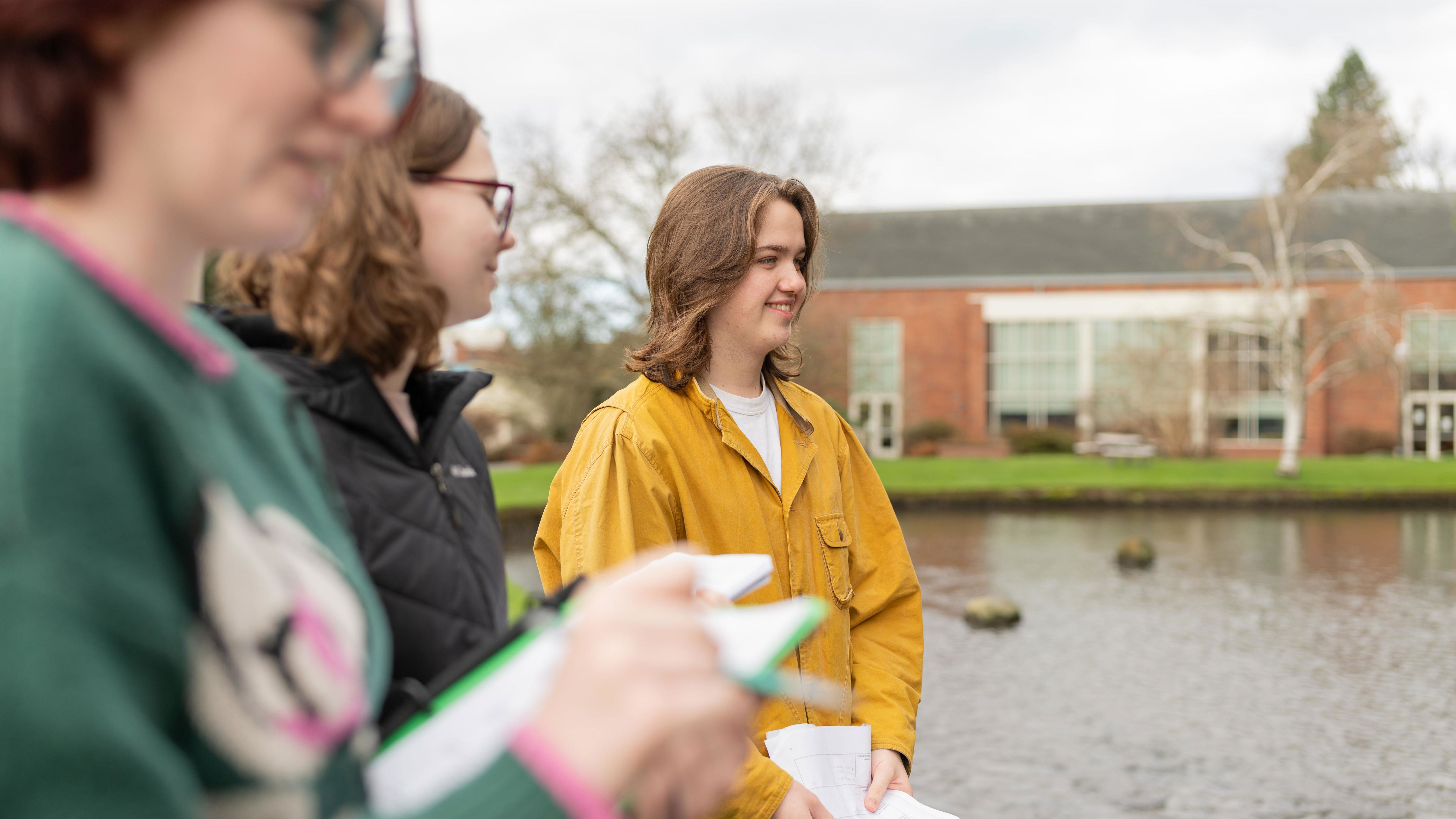 Students standing on the site of the mill stream. 