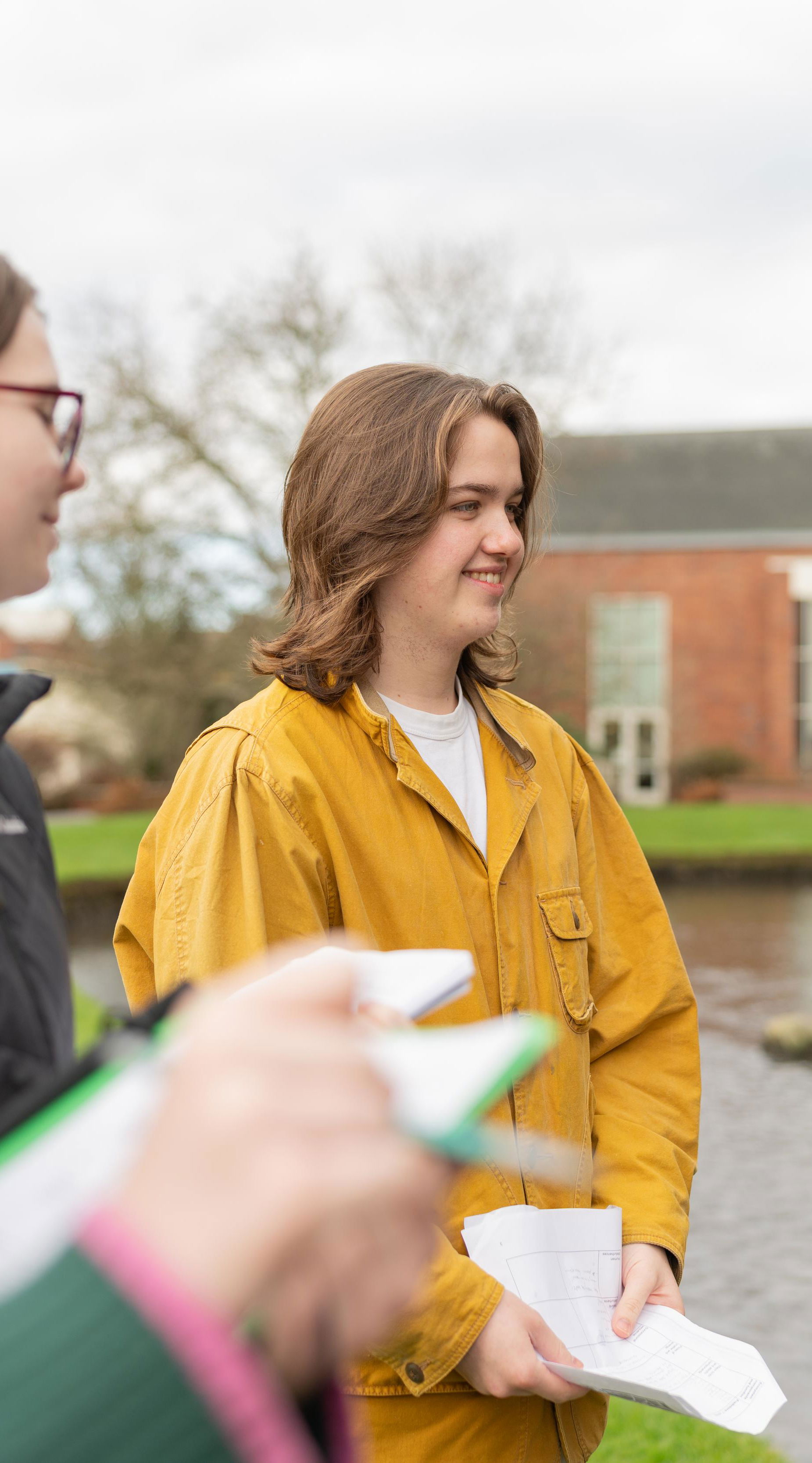 Students standing on the site of the mill stream. 