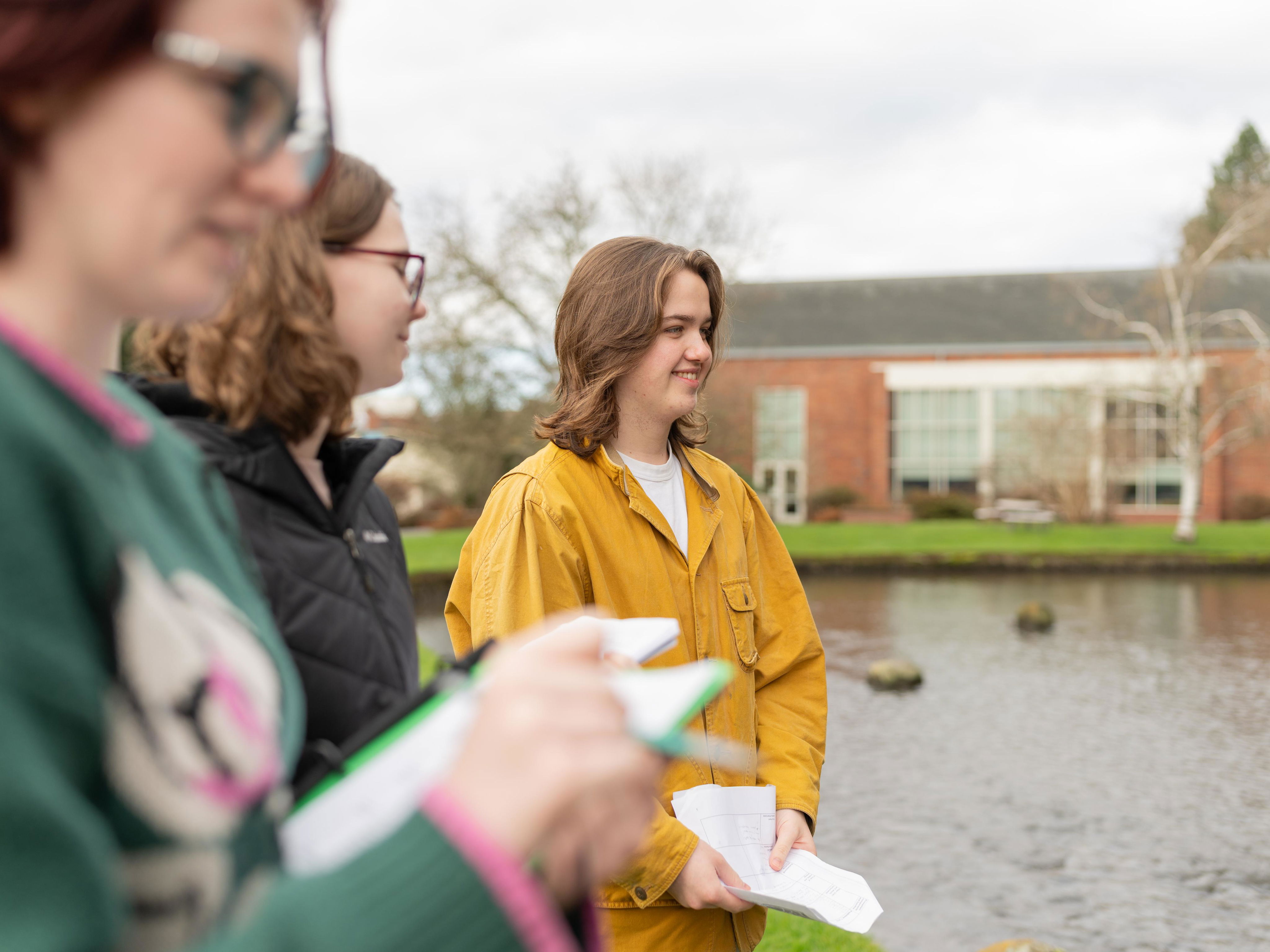 Students standing on the site of the mill stream. 