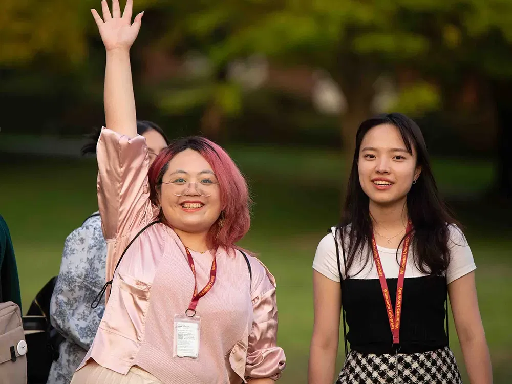 Two Willamette students - one is waving hello.