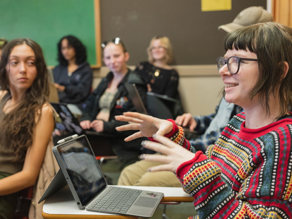 Woman expressing a thought surrounded by other students