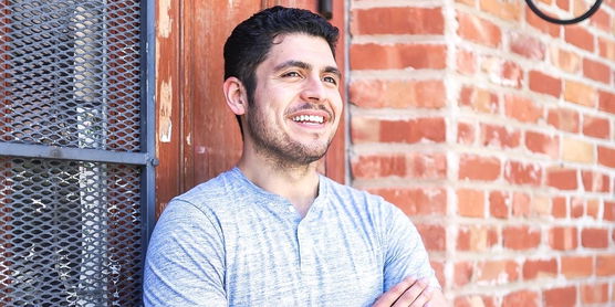 Jose Alvarado standing next to a wall looking off camera. 