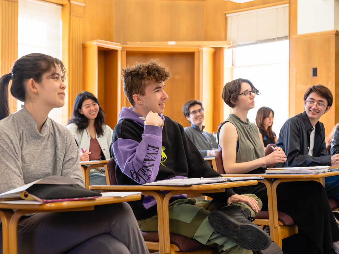 A group of students smiling in a classroom