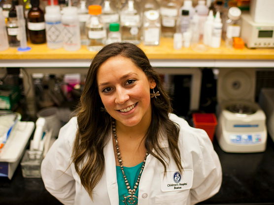 Victoria Black Horse smiling at the camera while in a science lab. 