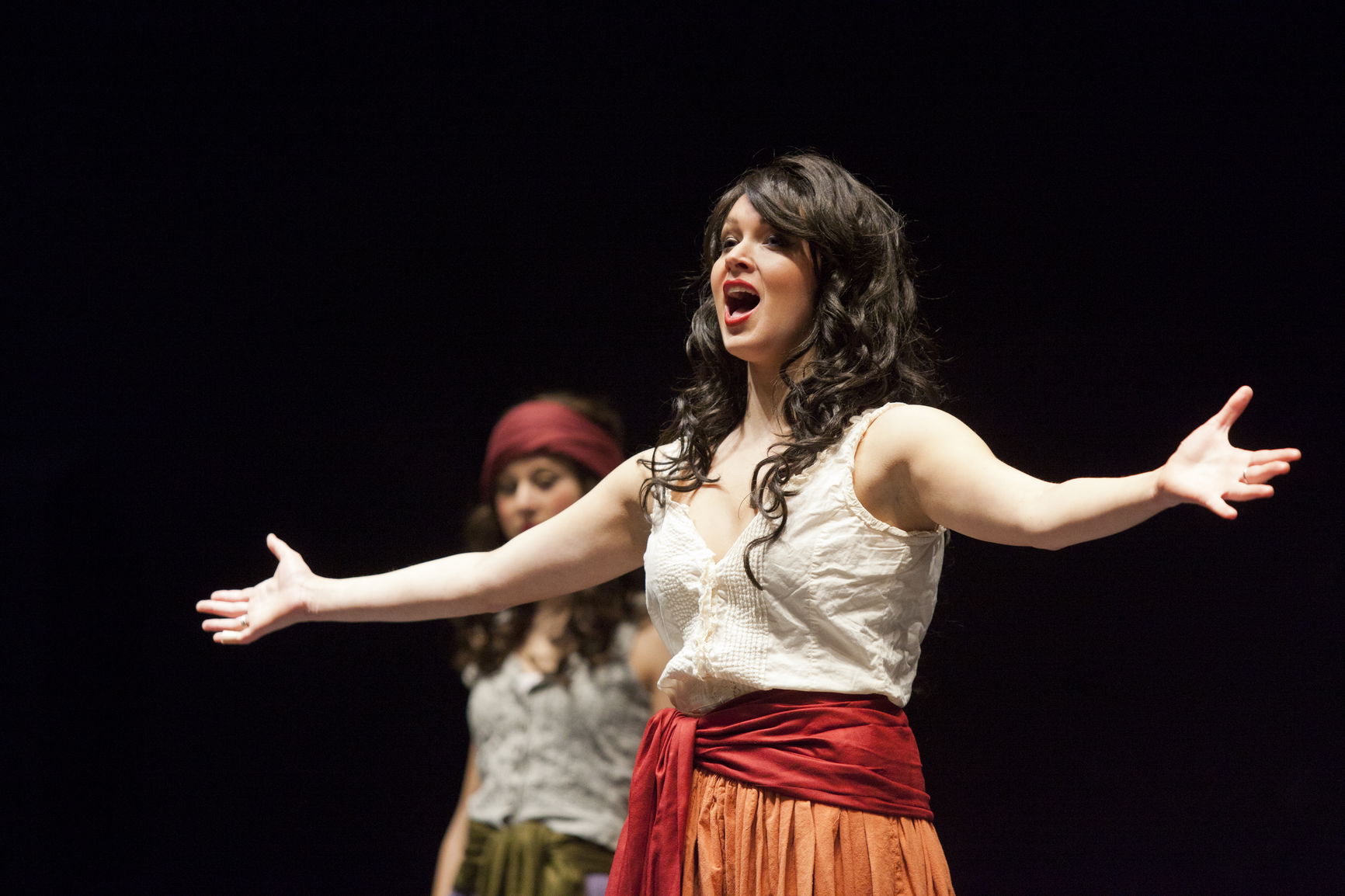 A student singing during an opera production