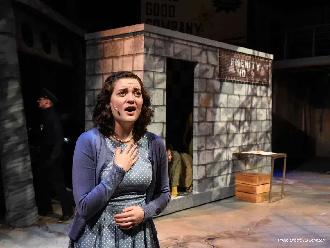 One performer on stage singing during a Willamette Theatre production