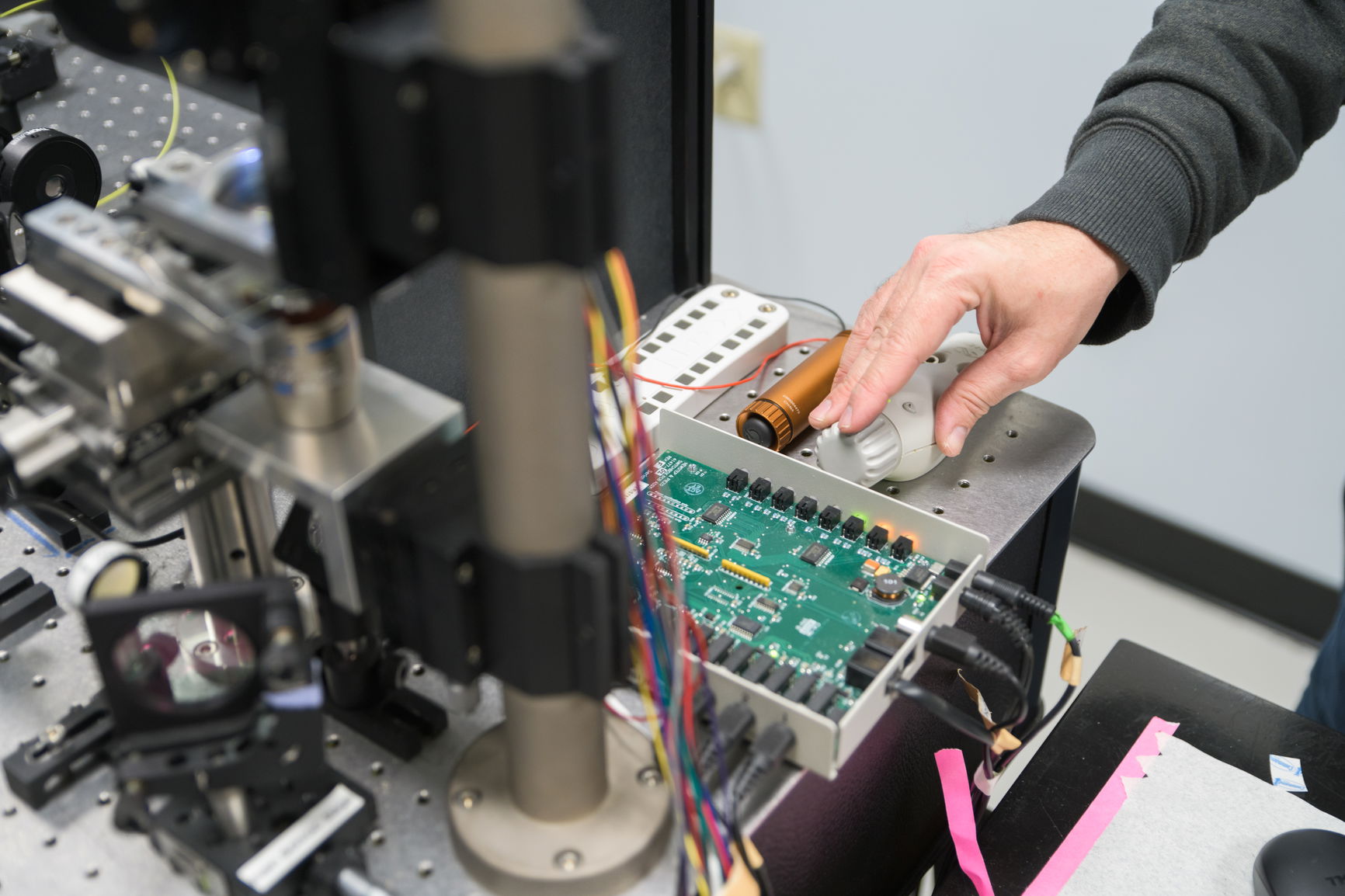 A student test using equipment in a physics lab