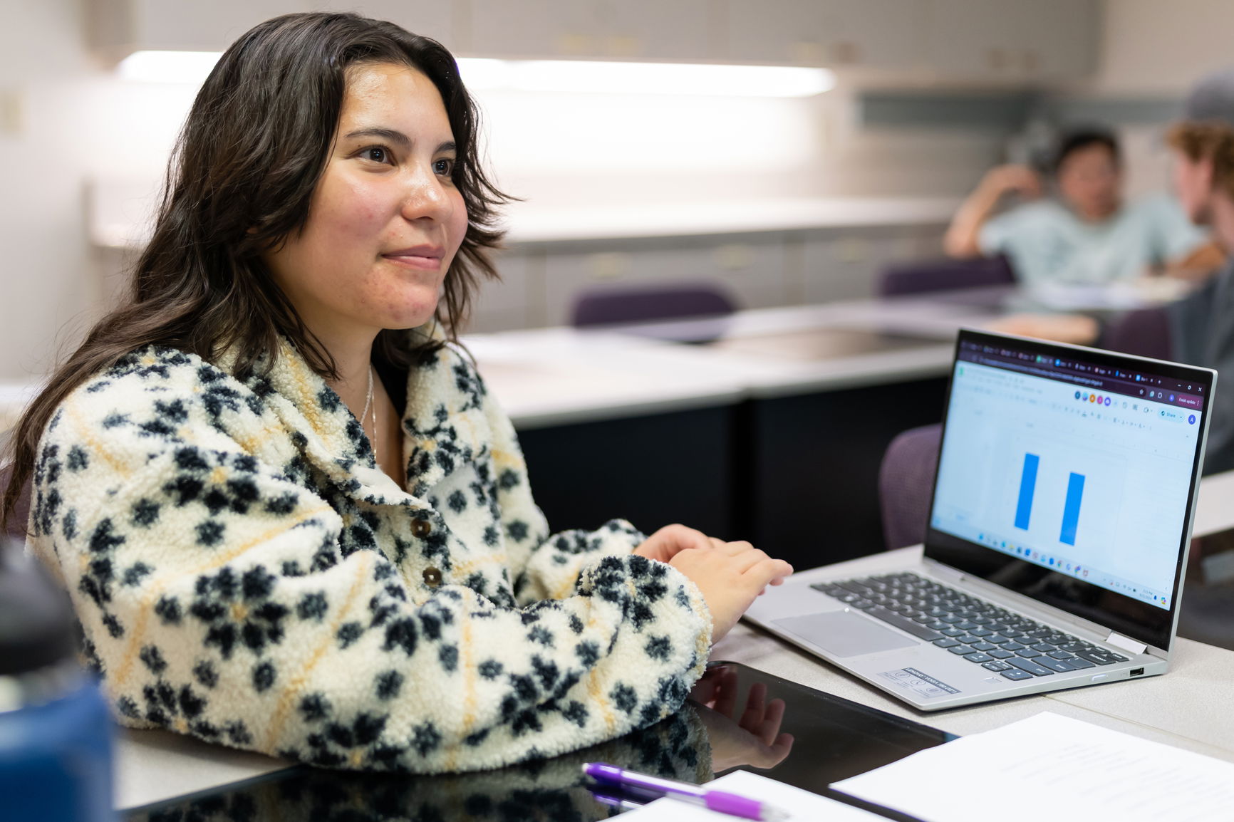 Student smiling while look away from the camera. 